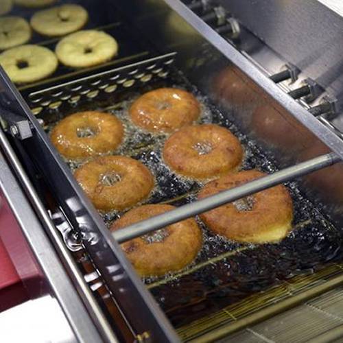 Several doughnut on the conveyor belts.